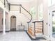 Stunning foyer featuring a curved staircase, marble floors, and a sophisticated design at 1700 White Pond Ln, Waxhaw, NC 28173