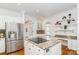 Bright kitchen with stainless appliances, center island, granite countertops, and modern fixtures at 1700 White Pond Ln, Waxhaw, NC 28173