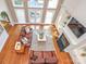 Aerial view of a cozy living room with a fireplace, plush sofas, and a large window at 1700 White Pond Ln, Waxhaw, NC 28173