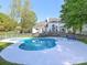 Backyard showcasing the in-ground pool with a large outdoor patio and landscaped yard at 1700 White Pond Ln, Waxhaw, NC 28173