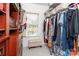 Organized walk-in closet with custom wood shelving and an ottoman by the window at 1700 White Pond Ln, Waxhaw, NC 28173