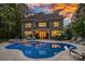 Stunning backyard features a large pool, spa, and outdoor seating area, perfect for entertaining and relaxation at 1717 Brawley School Rd, Mooresville, NC 28117