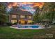 A well-maintained backyard features a beautiful pool, spacious patio, and lush landscaping, perfect for outdoor entertaining at 1717 Brawley School Rd, Mooresville, NC 28117