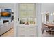 Elegant bar area features glass cabinets, geometric backsplash, marble countertop, and gold hardware at 1717 Brawley School Rd, Mooresville, NC 28117