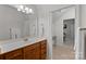 Bathroom with wood cabinets and white countertop with view to secondary space at 1717 Brawley School Rd, Mooresville, NC 28117