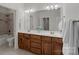 Bathroom with double vanity, wood cabinets, large mirror, and tub-shower combo at 1717 Brawley School Rd, Mooresville, NC 28117