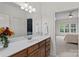 Bathroom featuring wooden cabinets, white countertops, and views into a bedroom at 1717 Brawley School Rd, Mooresville, NC 28117
