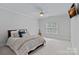 Bright bedroom with large window, ceiling fan, and neutral tones create a relaxing atmosphere at 1717 Brawley School Rd, Mooresville, NC 28117