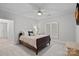 Bright bedroom features a ceiling fan, neutral colors, and large window with plantation shutters at 1717 Brawley School Rd, Mooresville, NC 28117