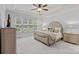 Primary bedroom features a tray ceiling, plush carpeting, and a large window at 1717 Brawley School Rd, Mooresville, NC 28117