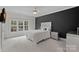 This bedroom features a modern design with a large window and a sleek black accent wall at 1717 Brawley School Rd, Mooresville, NC 28117