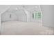 Large, light-filled bonus room with neutral carpet and charming window details at 1717 Brawley School Rd, Mooresville, NC 28117