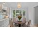 Cozy dining area with natural light and backyard views, with modern light fixture and decor at 1717 Brawley School Rd, Mooresville, NC 28117