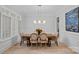 Formal dining room features a stylish table with seating for six and elegant decor at 1717 Brawley School Rd, Mooresville, NC 28117