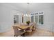 Bright dining room features hardwood floors, modern chandelier, and a large window with natural light at 1717 Brawley School Rd, Mooresville, NC 28117