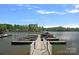 A private dock on a serene lake, offering easy access to boating and water activities, nestled among beautiful waterfront homes at 1717 Brawley School Rd, Mooresville, NC 28117