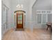 Welcoming foyer features a wood front door, chandelier, and beautiful hardwood flooring at 1717 Brawley School Rd, Mooresville, NC 28117