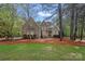 A distinguished brick home with manicured landscaping, featuring a well-maintained lawn and mature trees at 1717 Brawley School Rd, Mooresville, NC 28117