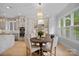Bright kitchen with a breakfast table and stylish chandelier, complemented by custom cabinets and modern appliances at 1717 Brawley School Rd, Mooresville, NC 28117