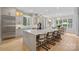 Bright kitchen with a large island, stainless steel appliances, and custom cabinetry, with a view into the breakfast nook at 1717 Brawley School Rd, Mooresville, NC 28117