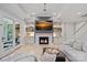 Bright living room with fireplace, TV, built-in shelving, and hardwood floors, perfect for relaxation at 1717 Brawley School Rd, Mooresville, NC 28117