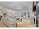 Spacious living room with hardwood floors and access to the screened porch and backyard pool at 1717 Brawley School Rd, Mooresville, NC 28117