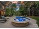 A tranquil pool area with a built-in spa and comfortable seating, surrounded by lush landscaping for ultimate relaxation at 1717 Brawley School Rd, Mooresville, NC 28117