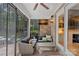 Relaxing screened porch with comfortable seating, brick accents, and views of the backyard at 1717 Brawley School Rd, Mooresville, NC 28117