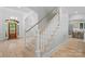 Elegant staircase with wood and white accents connects the levels in this beautifully designed home at 1717 Brawley School Rd, Mooresville, NC 28117