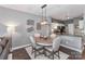 Dining area features modern light fixture, round table, and four chairs near open kitchen at 18832 Nautical Dr # 41, Cornelius, NC 28031