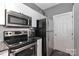 This kitchen features stainless steel appliances, white cabinets, and a subway tile backsplash at 18832 Nautical Dr # 41, Cornelius, NC 28031