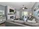 Comfortable living room with stone fireplace, TV, patio access, and cozy seating at 18832 Nautical Dr # 41, Cornelius, NC 28031