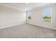 Light-filled bedroom with two windows and neutral carpeting at 1930 Old Rivers Rd, Concord, NC 28027