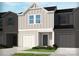 Charming townhome featuring a one-car garage and a covered entrance, all surrounded by nicely landscaped gardens at 1930 Old Rivers Rd, Concord, NC 28027