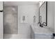Bathroom featuring a gray vanity with marble countertop, shower with gray tile and a black framed mirror at 2027 Thurmond Pl, Charlotte, NC 28205