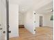 Bright entryway showcasing light hardwood floors, white walls, and a glimpse into the spacious, open layout of the home at 2027 Thurmond Pl, Charlotte, NC 28205
