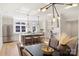 Open-concept kitchen and dining area with stainless steel appliances, pendant lighting, and hardwood floors at 2027 Thurmond Pl, Charlotte, NC 28205