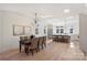 Spacious kitchen and dining area with sleek lighting, stainless steel appliances, seamlessly connecting to living spaces at 2027 Thurmond Pl, Charlotte, NC 28205