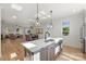 Open kitchen view highlighting quartz countertops, stainless steel appliances, and seamless flow to the dining and living areas at 2027 Thurmond Pl, Charlotte, NC 28205