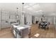 Bright kitchen connects to dining area; showcasing quartz island, modern appliances, and stylish pendant lighting at 2027 Thurmond Pl, Charlotte, NC 28205
