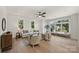 Bright living room with large windows, ceiling fan, hardwood floors, and comfortable seating arrangement at 2027 Thurmond Pl, Charlotte, NC 28205