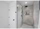 Modern tiled shower with glass door and sleek fixtures in the updated bathroom at 2027 Thurmond Pl, Charlotte, NC 28205