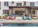 Beautiful backyard featuring a pristine pool, outdoor seating, and lush landscaping perfect for relaxation and entertainment at 2137 Foxcroft Woods Ln, Charlotte, NC 28211