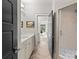 Bathroom with a modern vanity, a glass enclosed shower, and stylish herringbone pattern tile flooring at 2137 Foxcroft Woods Ln, Charlotte, NC 28211