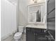Cozy bathroom featuring modern fixtures, a vanity with storage, and a shower with a white curtain at 2137 Foxcroft Woods Ln, Charlotte, NC 28211