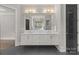 Bright bathroom featuring double sinks, a large mirror, and modern fixtures; a well-lit and stylish space at 2137 Foxcroft Woods Ln, Charlotte, NC 28211