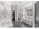 Bright bathroom featuring a soaking tub, modern fixtures, and a window for natural light; a spa-like retreat at 2137 Foxcroft Woods Ln, Charlotte, NC 28211