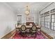 Formal dining room with a large table, elegant chandelier, and stylish rug at 2137 Foxcroft Woods Ln, Charlotte, NC 28211