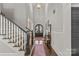 Light-filled foyer with hardwood floors, staircase and elegant decor creates a welcoming atmosphere at 2137 Foxcroft Woods Ln, Charlotte, NC 28211