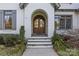 Elegant arched entryway with double doors, providing a grand welcome to the home at 2137 Foxcroft Woods Ln, Charlotte, NC 28211